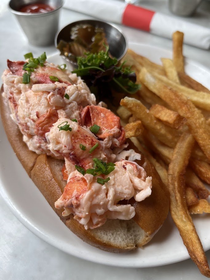 Raw bar seating and lobster dishes in a casual dining room.